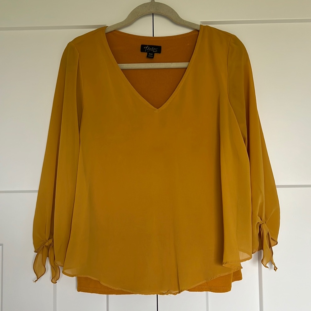 Golden yellow blouse with three-quarter sleeves